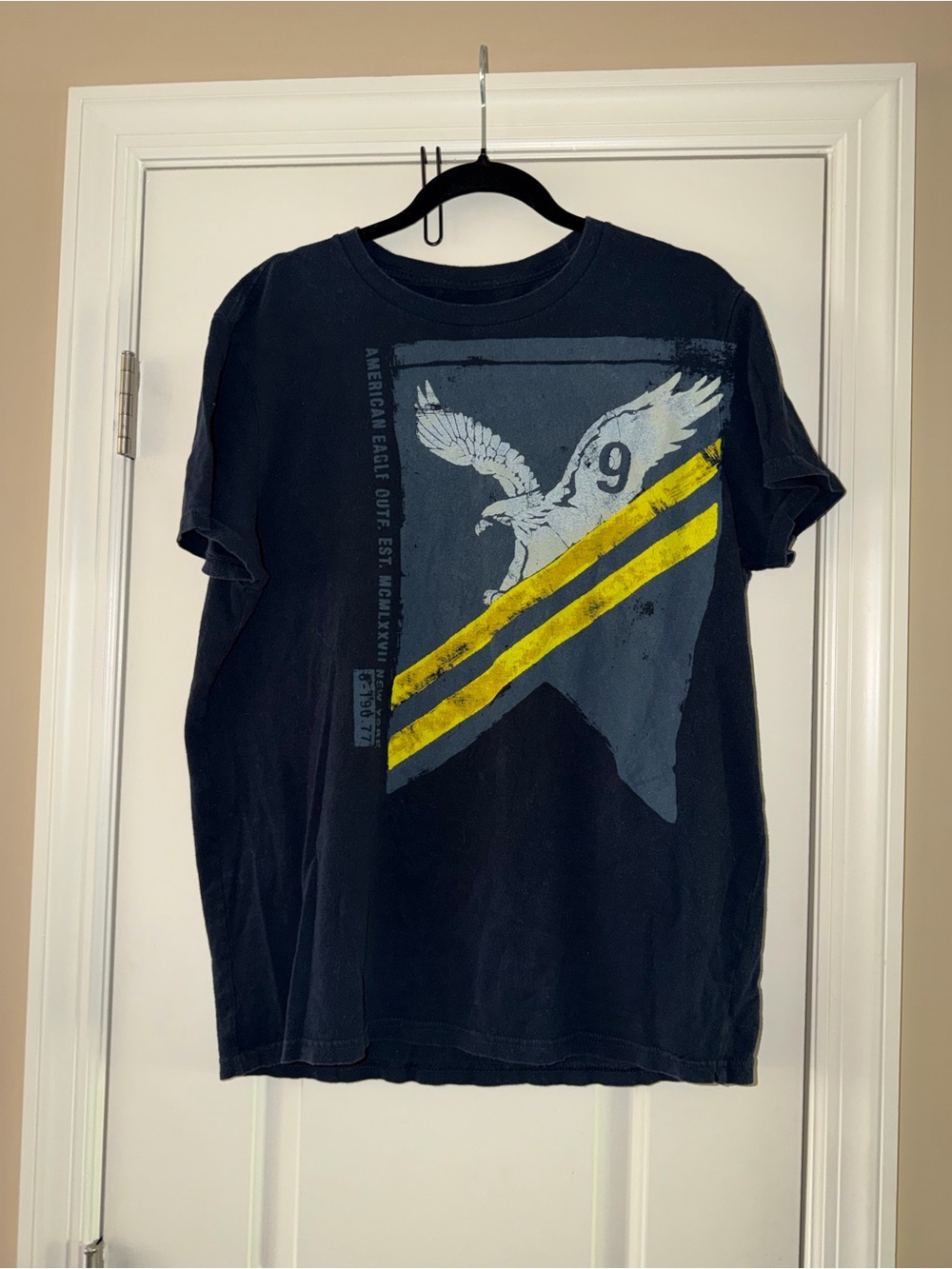 American Eagle Outfitters Black Tee with Yellow Stripe and Eagle Graphic